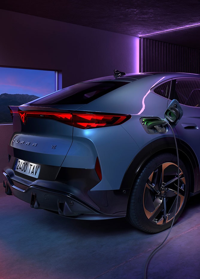 A CUPRA Tavascan being charged from a wall charger